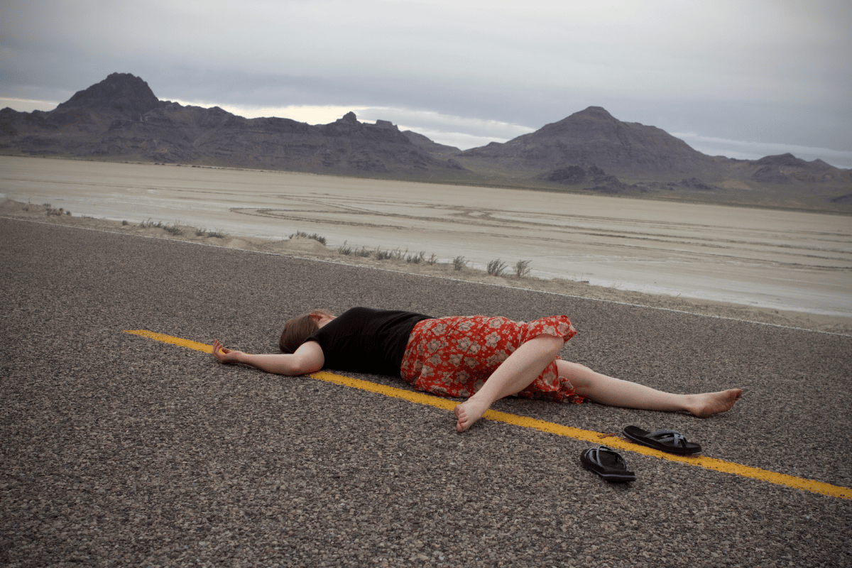 injured woman lying on road unattended