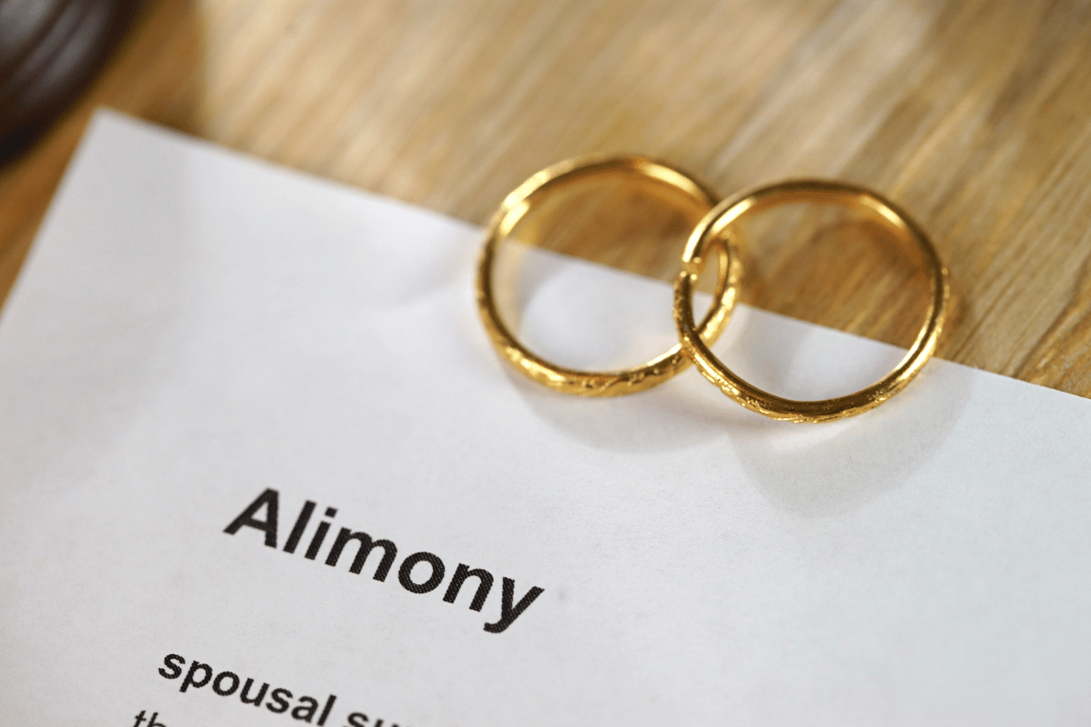 two wedding bands on alimony document